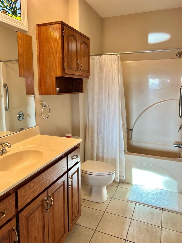full bathroom featuring vanity, toilet, tile patterned flooring, and shower / bath combo