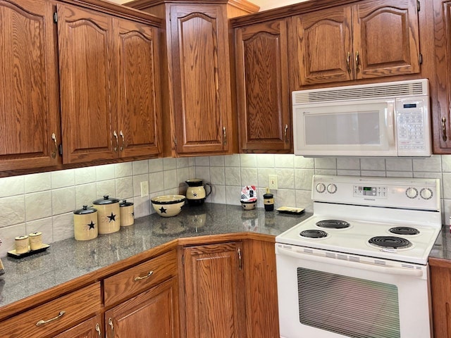 kitchen with white appliances and decorative backsplash