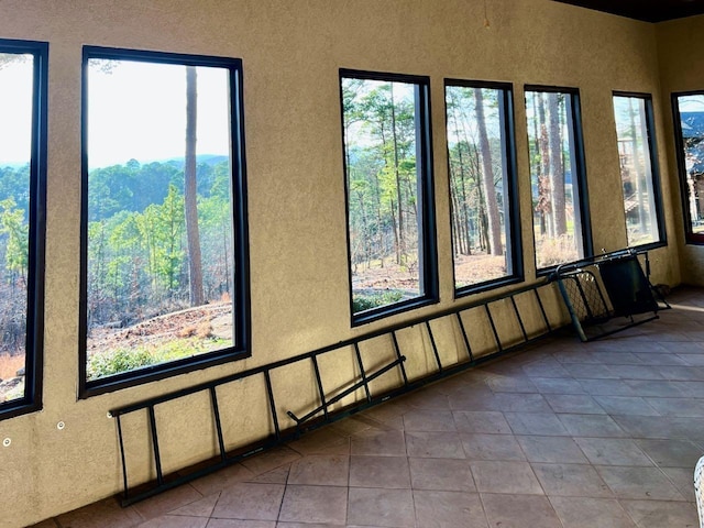 unfurnished sunroom with plenty of natural light