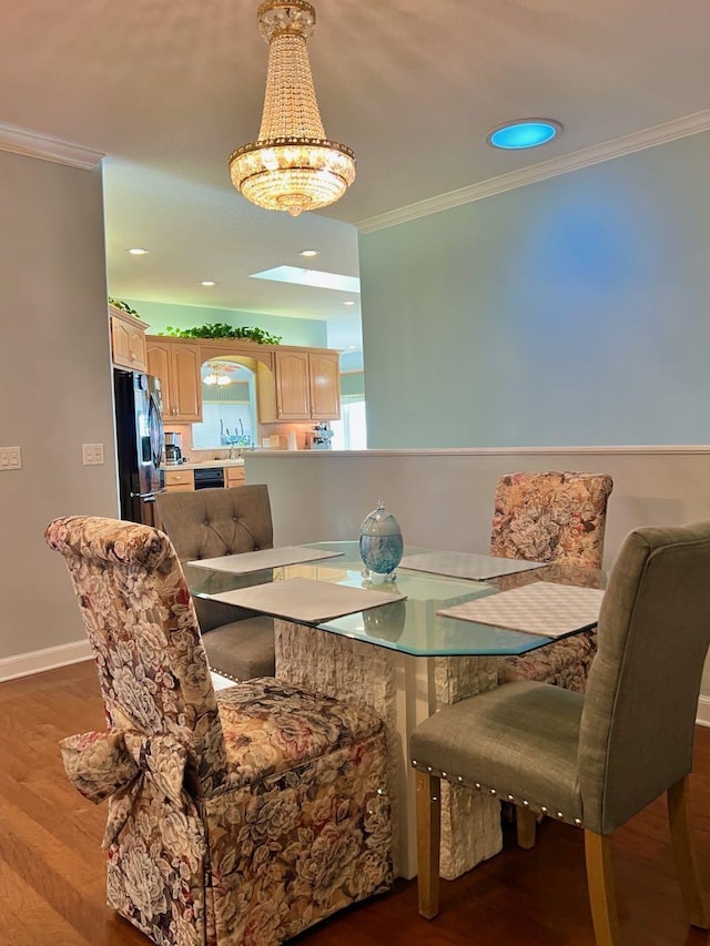 dining space featuring ornamental molding and dark hardwood / wood-style flooring
