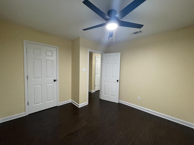 unfurnished bedroom with ceiling fan and dark hardwood / wood-style flooring