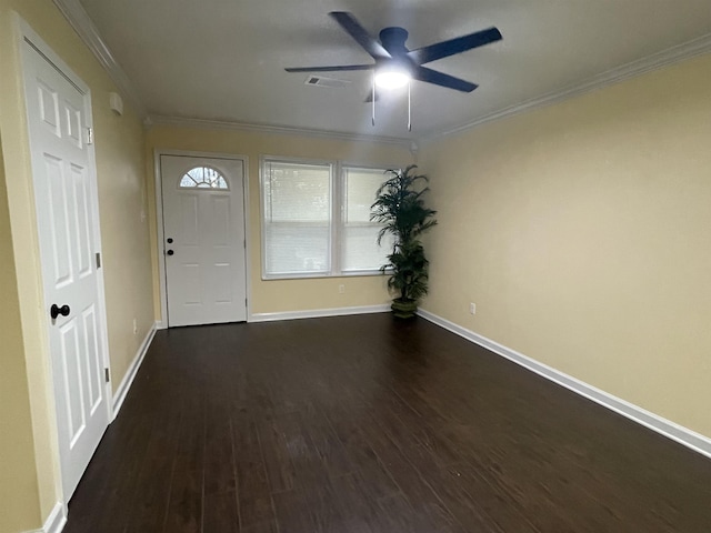 foyer entrance with dark wood-type flooring, ceiling fan, and ornamental molding