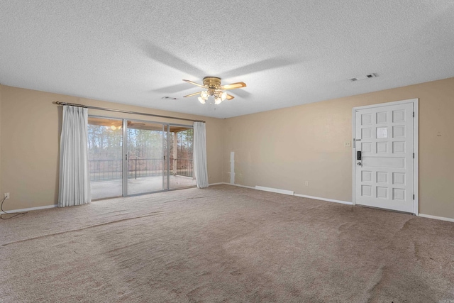 carpeted empty room with a textured ceiling and ceiling fan