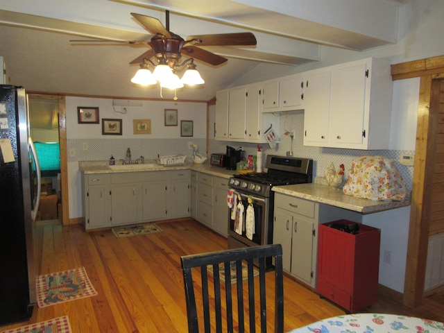 kitchen with appliances with stainless steel finishes, sink, light hardwood / wood-style flooring, and backsplash