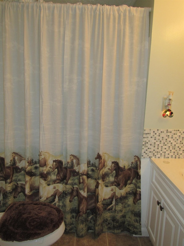 bathroom featuring vanity, toilet, and tile patterned flooring