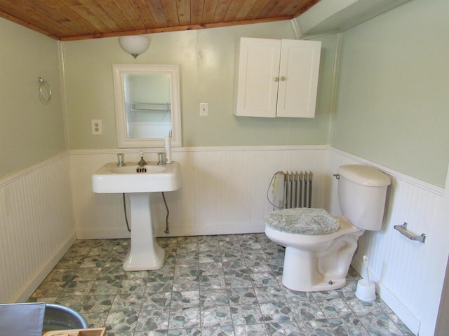 bathroom with radiator, wooden ceiling, and toilet