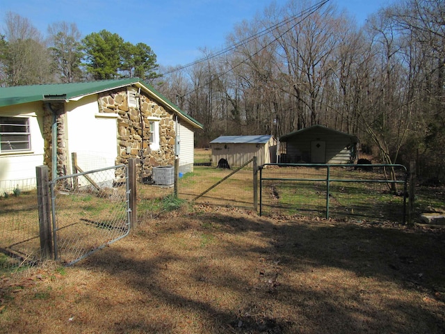 view of yard with cooling unit and a storage unit