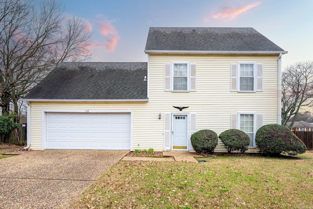 view of front facade featuring a garage and a lawn