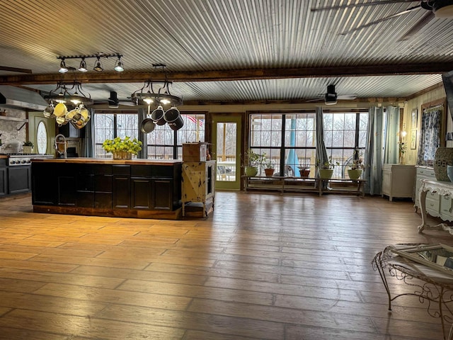 interior space with hanging light fixtures, a healthy amount of sunlight, ceiling fan, and light hardwood / wood-style flooring