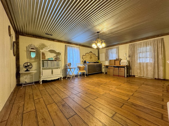 bedroom with a chandelier and hardwood / wood-style floors