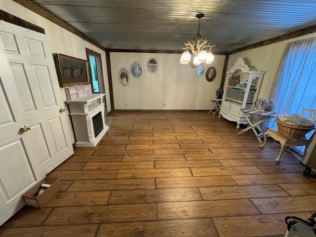 interior space with an inviting chandelier, ornamental molding, wood-type flooring, and wood ceiling