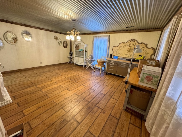 dining space featuring hardwood / wood-style floors and a chandelier