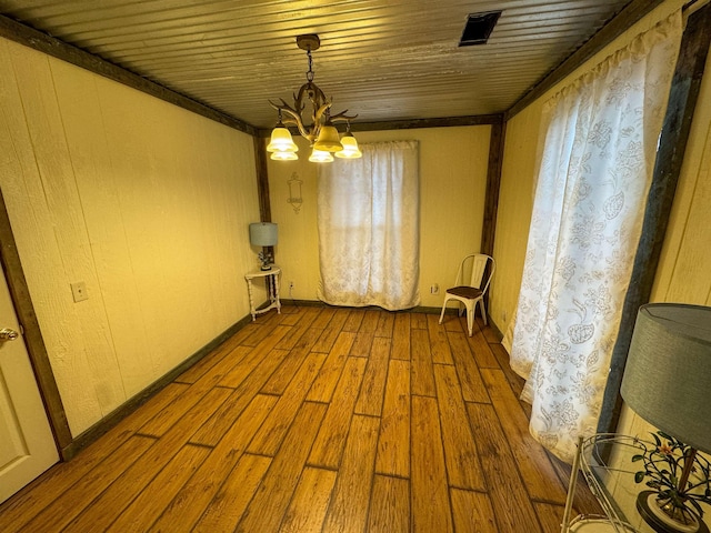 unfurnished room featuring wood ceiling, a notable chandelier, and light wood-type flooring