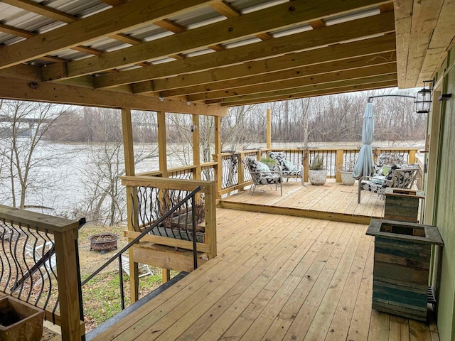 snow covered deck with an outdoor fire pit