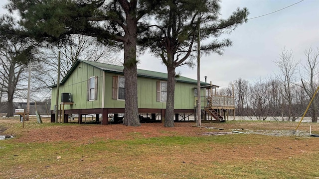 view of side of property with a lawn and central air condition unit