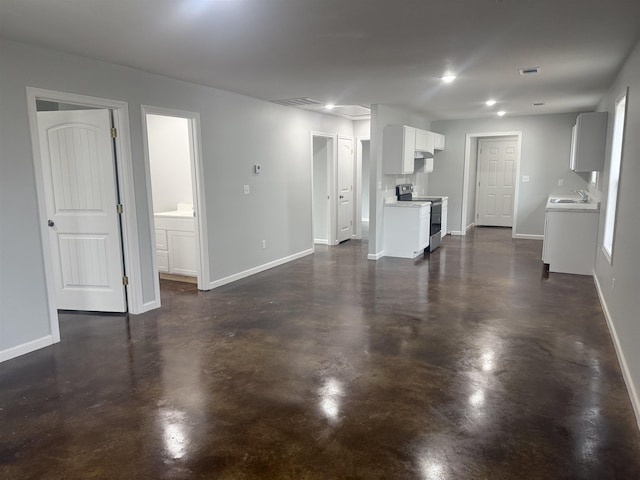 unfurnished living room featuring sink