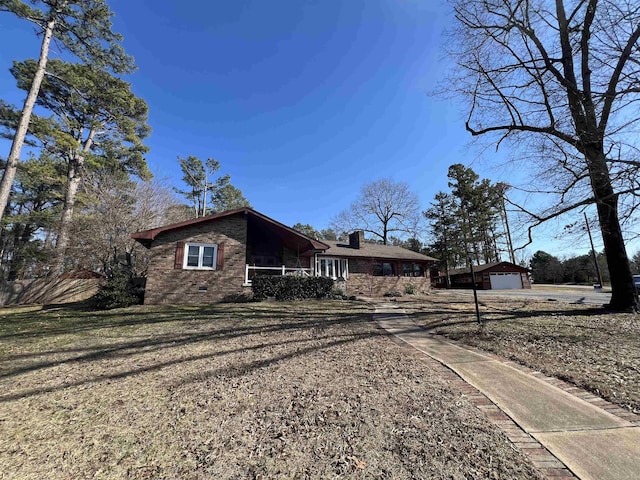 view of side of home with an outbuilding and a garage