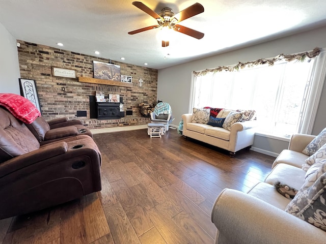 living room featuring hardwood / wood-style floors, a textured ceiling, ceiling fan, and brick wall