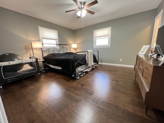 bedroom with dark wood-type flooring and ceiling fan