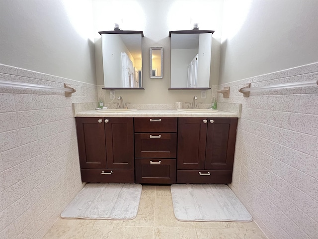 bathroom with tile patterned floors, vanity, and tile walls