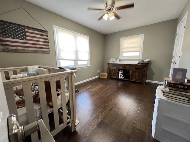 bedroom with ceiling fan and dark hardwood / wood-style flooring