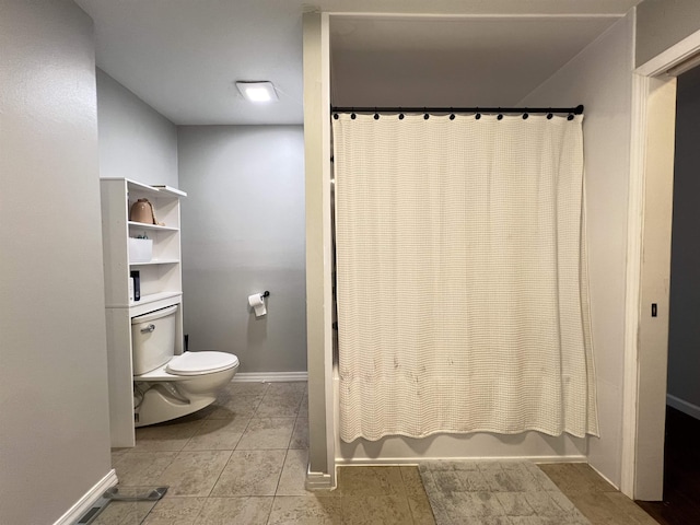 bathroom with shower / bath combination with curtain and toilet