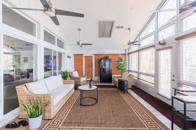 sunroom / solarium featuring vaulted ceiling, ceiling fan, and plenty of natural light