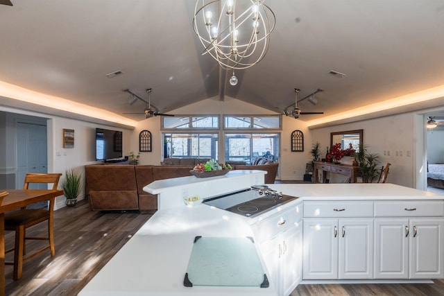 kitchen featuring dark wood-type flooring, vaulted ceiling, black electric cooktop, ceiling fan, and white cabinets