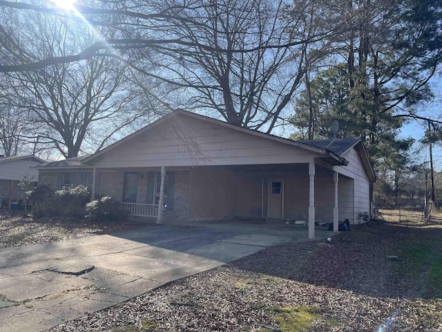 view of side of property with a carport and covered porch