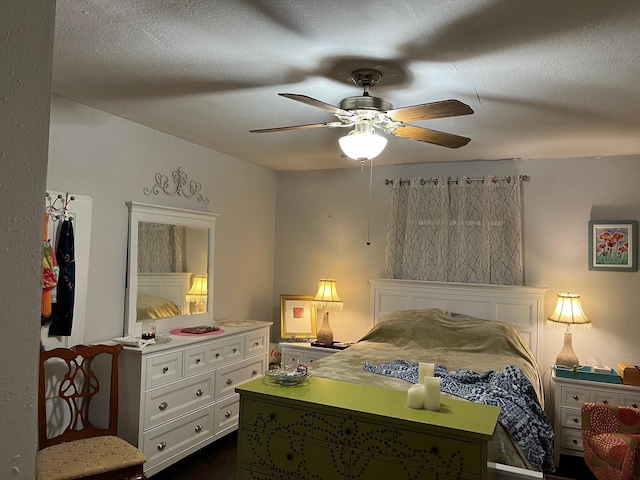 bedroom with ceiling fan and a textured ceiling