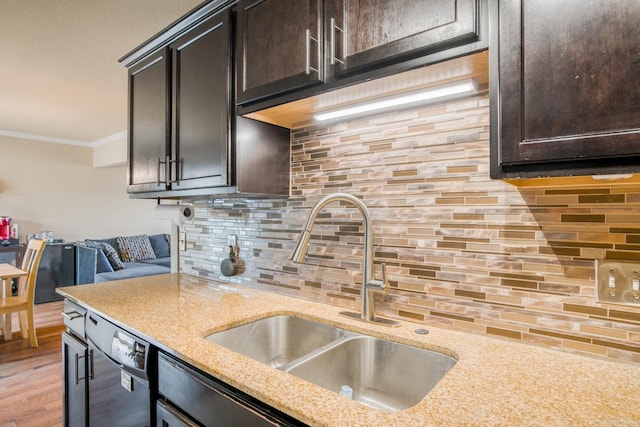 kitchen featuring dishwasher, sink, backsplash, crown molding, and dark brown cabinets