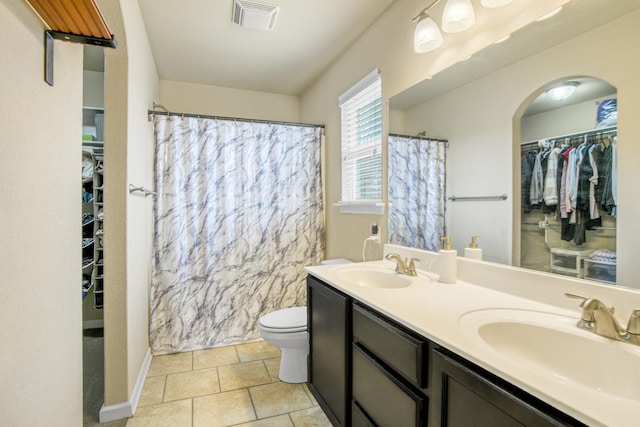 bathroom featuring vanity, toilet, curtained shower, and tile patterned flooring