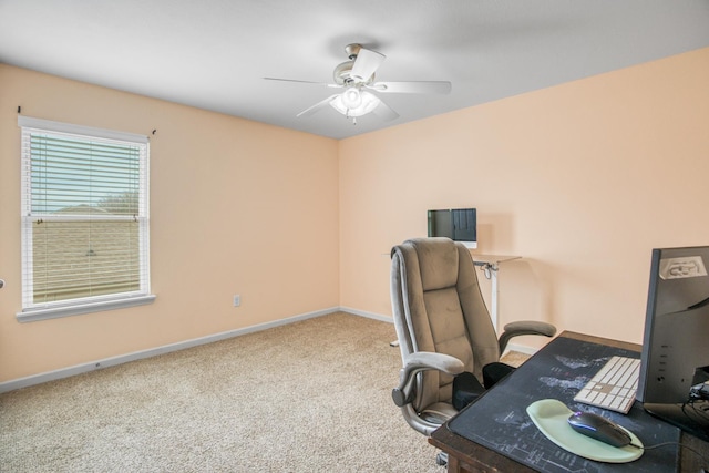 carpeted home office featuring ceiling fan