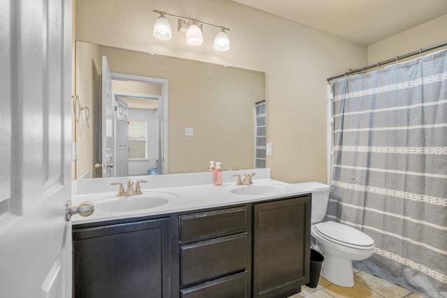 bathroom featuring tile patterned flooring, vanity, walk in shower, and toilet