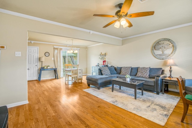 living room featuring ornamental molding, ceiling fan with notable chandelier, and light hardwood / wood-style flooring