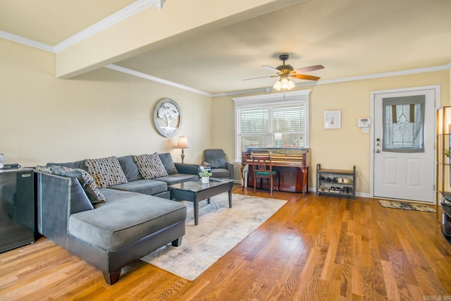 living room with crown molding, ceiling fan, and hardwood / wood-style floors