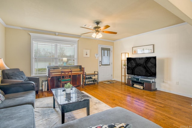 living room featuring crown molding, wood-type flooring, and ceiling fan