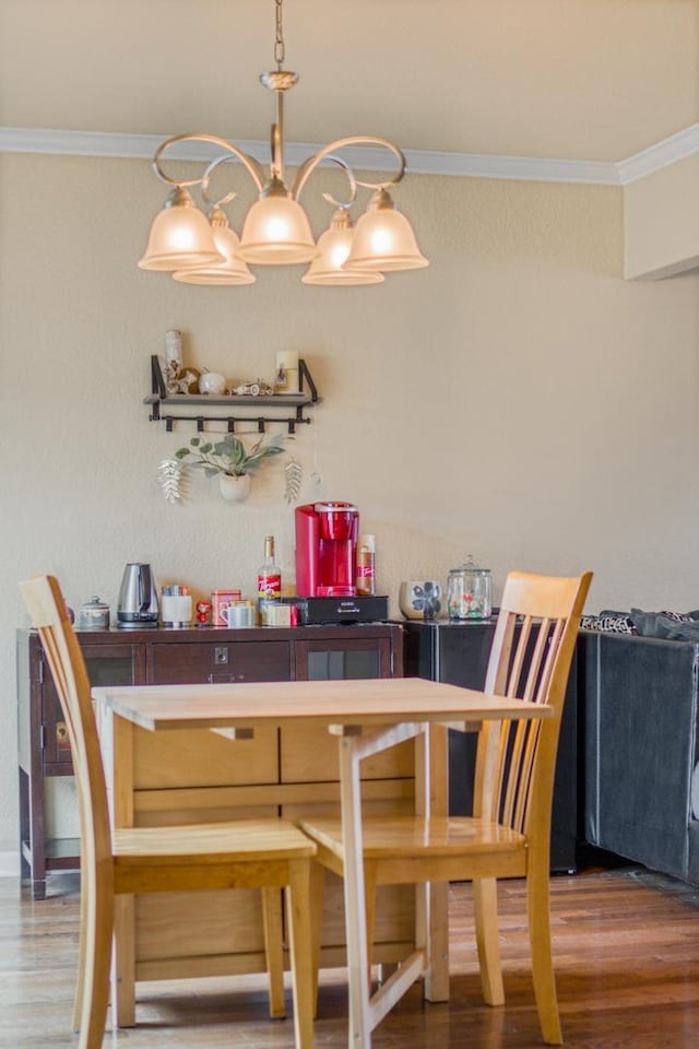 dining space featuring hardwood / wood-style flooring and ornamental molding