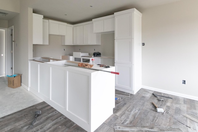 kitchen with white cabinetry and light hardwood / wood-style floors