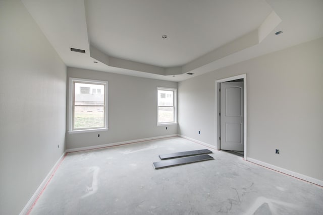 unfurnished room featuring a raised ceiling