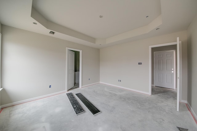 empty room featuring a raised ceiling