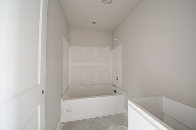 bathroom featuring concrete flooring and a bathing tub