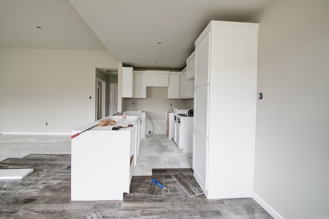 kitchen featuring hardwood / wood-style floors and white cabinets