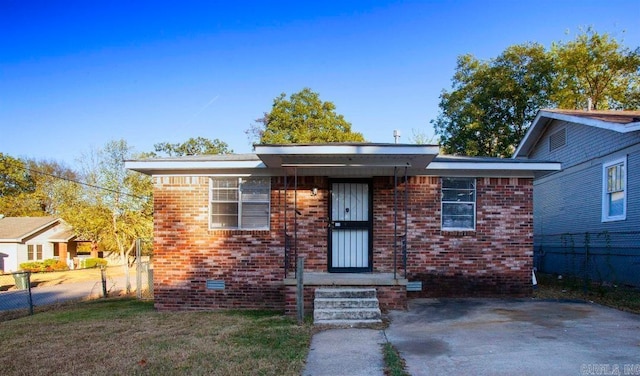 bungalow with brick siding, crawl space, a front lawn, and fence