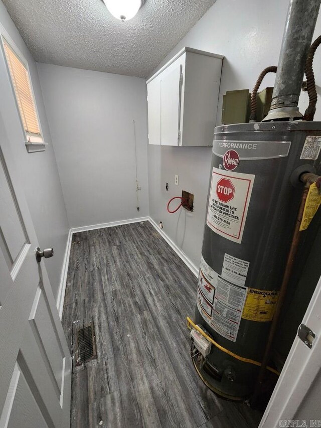 utilities with water heater and visible vents