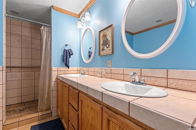 bathroom featuring vanity, ornamental molding, and walk in shower