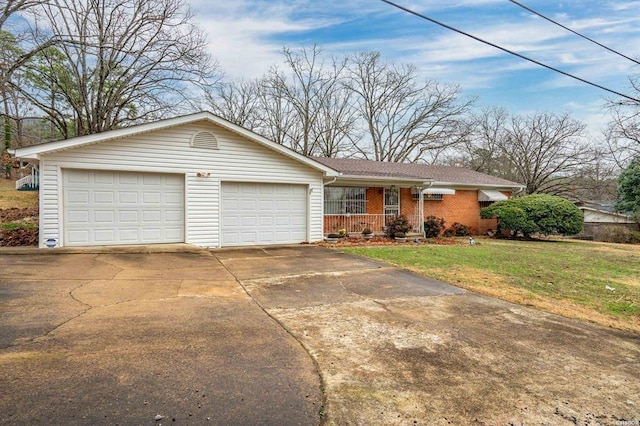 ranch-style house featuring a garage, covered porch, and a front lawn