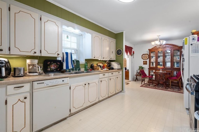 kitchen featuring a notable chandelier, dishwasher, ornamental molding, and white cabinets