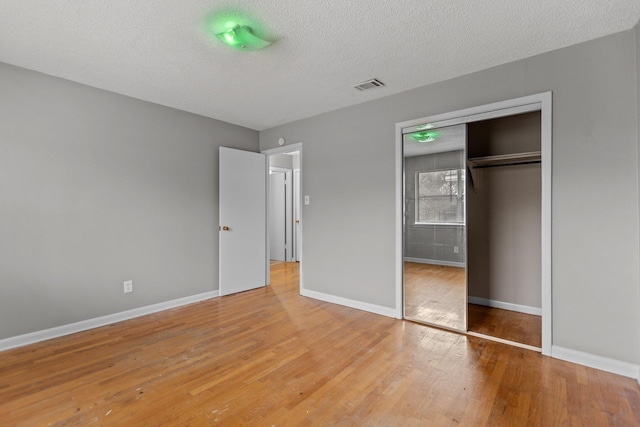 7305 Kentucky Ave, Little Rock, AR 72207 - unfurnished bedroom featuring hardwood / wood-style floors, a textured ceiling, and a closet