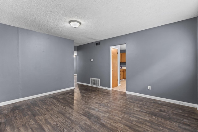 7305 Kentucky Ave, Little Rock, AR 72207 - empty room with dark hardwood / wood-style floors and a textured ceiling